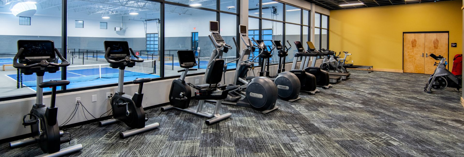 best-cardio-equipment-near-me-peak-id-gyms-post-falls a row of cardio training equipment at peak id gym in post falls