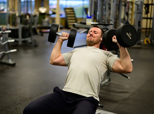 man working out with dumbbells