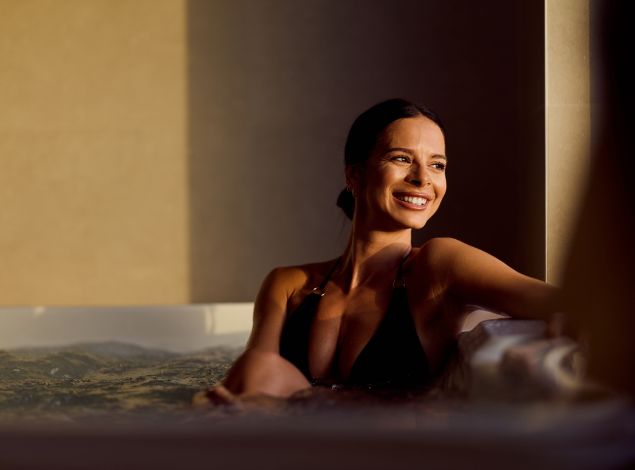 Woman relaxing in the women’s only Jacuzzi at PEAK Health & Wellness Coeur d’Alene for post-workout recovery