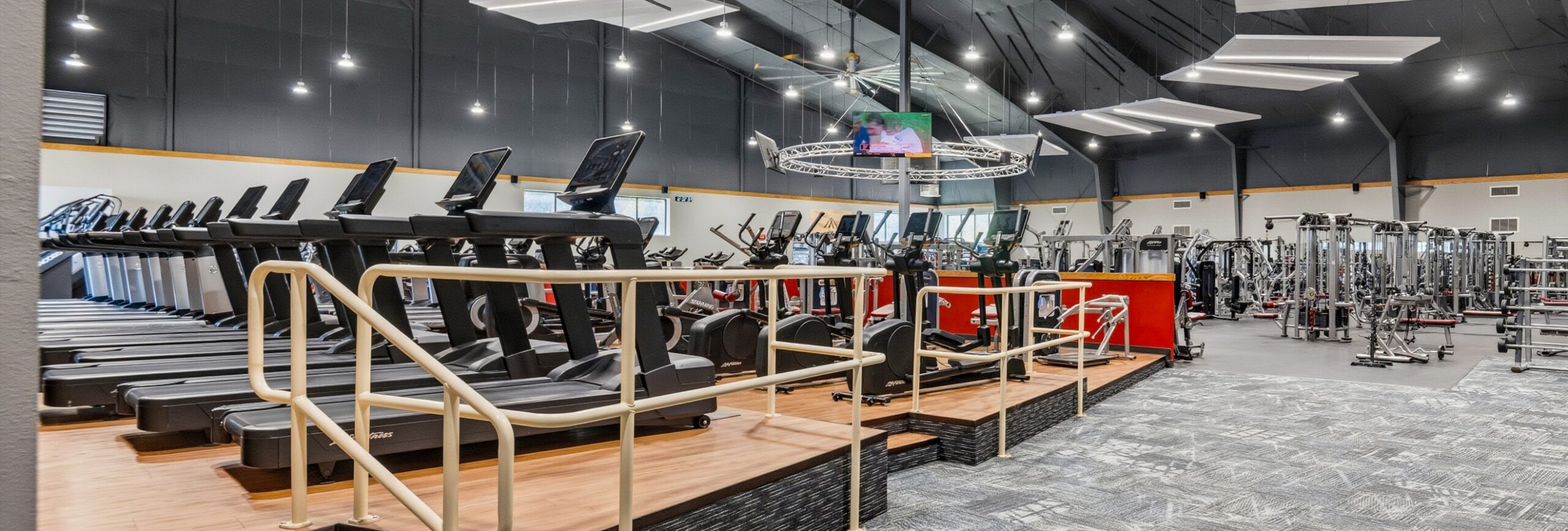 Cardio fitness floor with treadmills, ellipticals, and strength equipment at Peak Health & Wellness Coeur d’Alene.