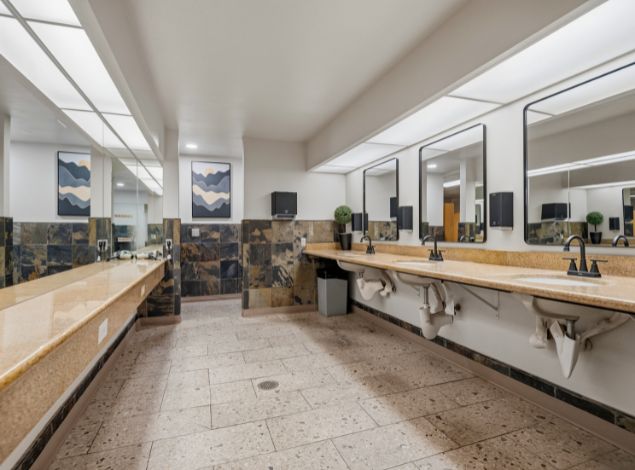 Clean locker room vanity area with sinks and mirrors at Peak Health & Wellness Coeur d'Alene.