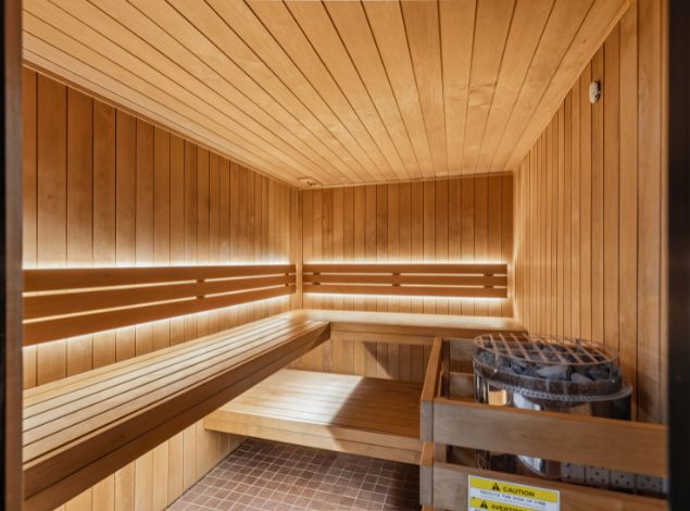 Wood-paneled sauna with heated benches in the recovery area at Peak Health & Wellness Coeur d'Alene.