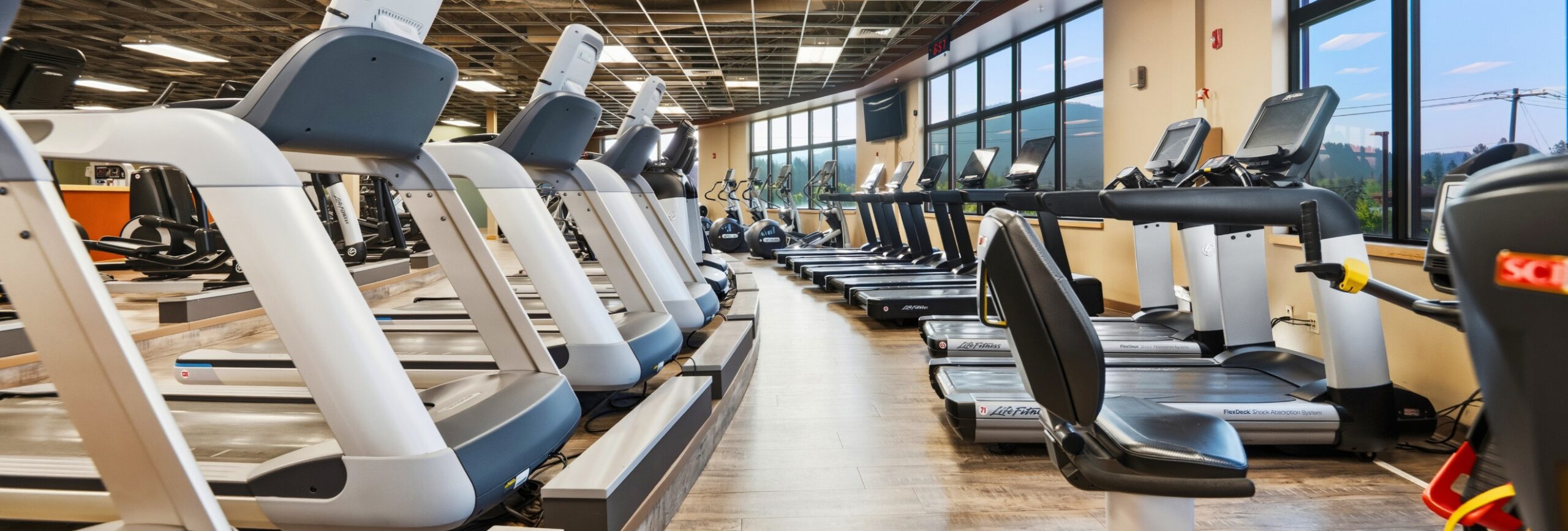 Cardio floor with treadmills, elliptical machines, and stationary bikes at Peak Health & Wellness Hayden.