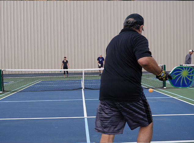 people playing pickleball indoors