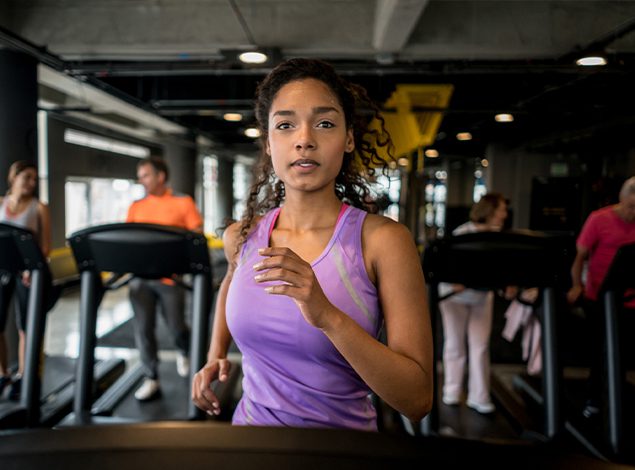 female gym member running on treadmill in missoula health club