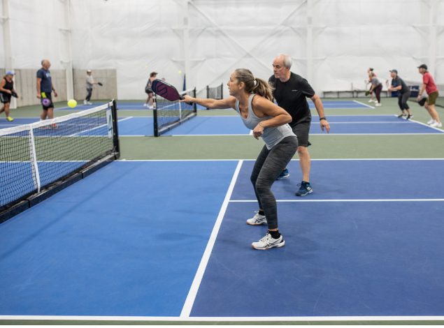 woman and man playing pickleball at a gym near me in missoula blue mountain fitness center