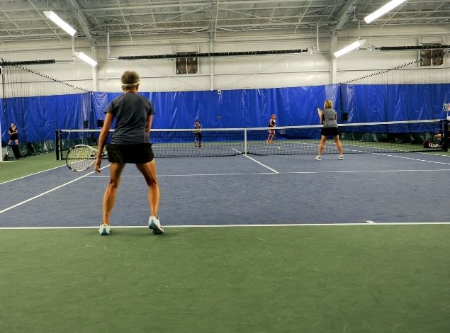 people playing tennis indoors