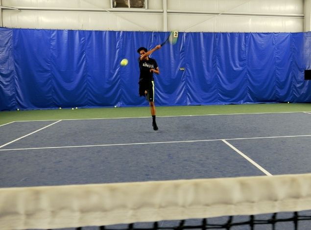 a man hitting a tennis ball