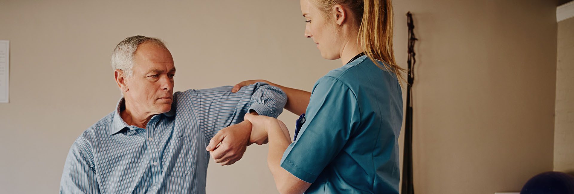 physical therapist working with client in a modern gym