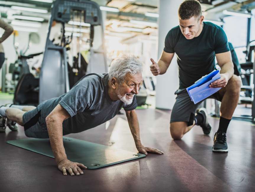 Personal trainer coaching client during strength workout at Peak Health & Wellness