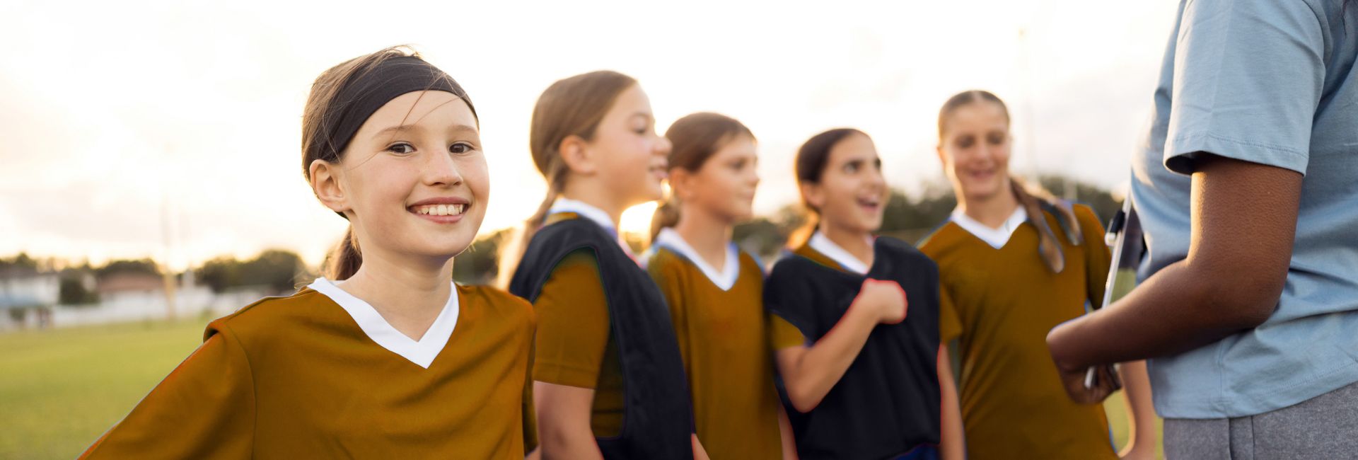 Youth sports team with coach participating in a community program supported by Peak Health & Wellness